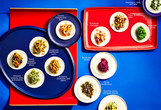 assortment of labeled dumplings on blue and red platters