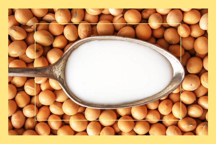 Top view of metallic spoon with soy milk on it